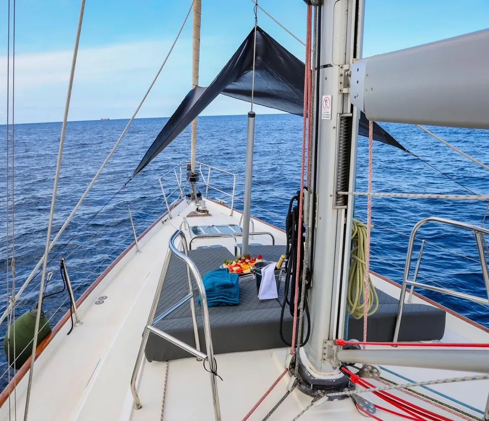 Shaded deck lounge on the Beneteau 50 with blue sea behind
