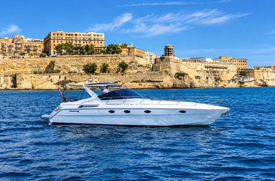 Cranchi Mediterranée 43 motor yacht cruising past Valletta's bastions