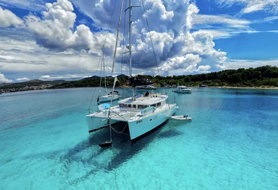 Lagoon 450 catamaran at anchor in clear turquoise water