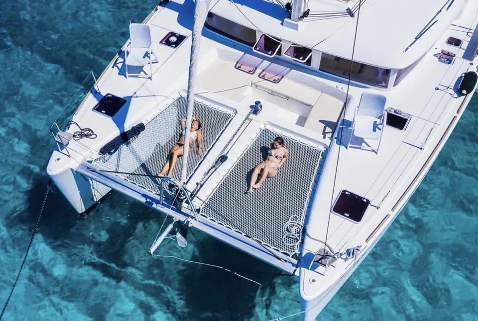 Guests sunbathing on the trampoline nets of the Lagoon 450