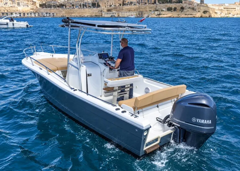 White Shark 25 day boat at speed with the captain at the helm